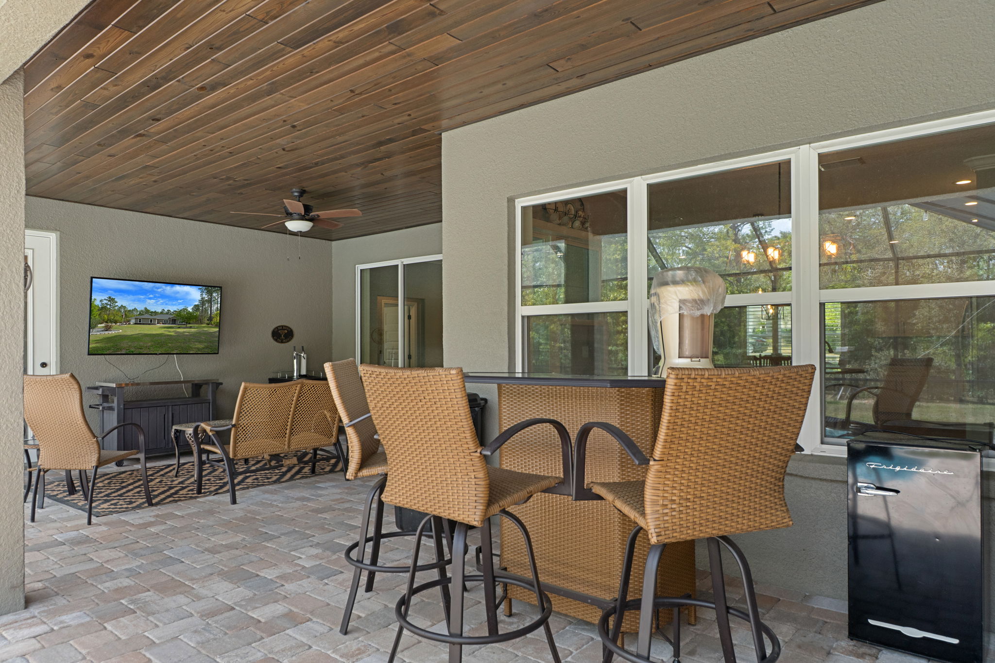 The covered lanai is a great entertaining space and is warmed by the polished wood ceiling.