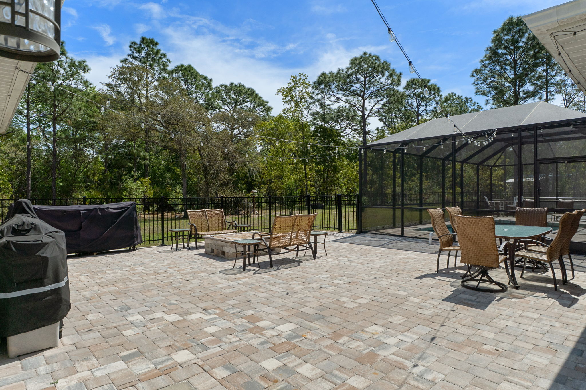 The outdoor patio with pavers and firepit provide additional room for entertaining and enjoying your own oasis.