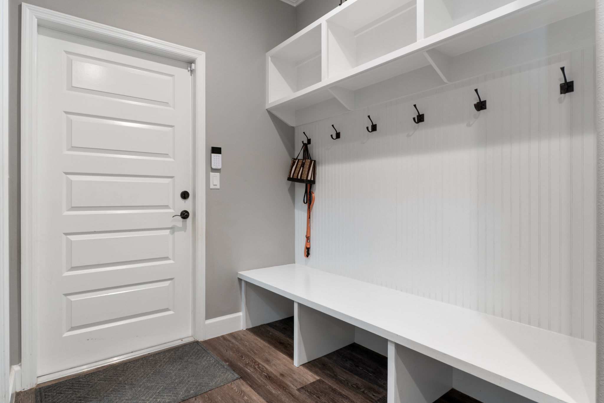 Just outside the pantry is the "mud room" hall. The closed door leads to the attached 2 car garage. The pantry is accessed on the left side, out of the picture.