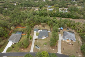 Front aerial view provides better view of vacant land behind lot that cannot be developed.