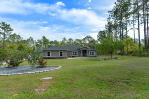 The home sits almost in the middle of the lot, allowing for generous space between the street and the home.