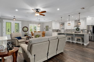 Standing near sliding door looking back toward the front door and across to the kitchen.
