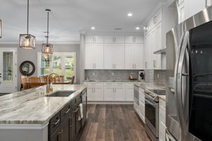 Looking from the breakfast nook, through the kitchen. At the far end, turn right to head to laundry room, mud room hall, and walk-in pantry.