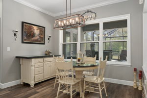 The spacious breakfast nook overlooks the lanai and pool.
