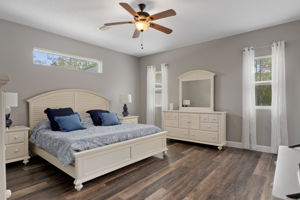 The primary bedroom is accessed off of the breakfast nook and is quite spacious. Notice the large bedroom furniture, including king size bed.