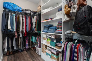 The oversized primary suite closet is 12'10" long and is separated from the bath with a pocket door.