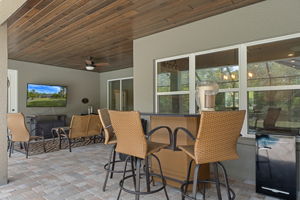 The covered lanai is a great entertaining space and is warmed by the polished wood ceiling.