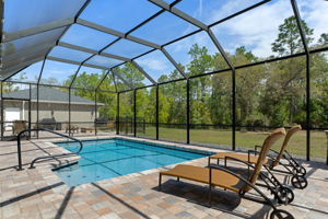 View from one end of the pool across to outdoor patio and firepit.