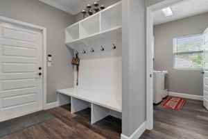 The "mud room" hall that leads to garage and connects laundry room to kitchen area.