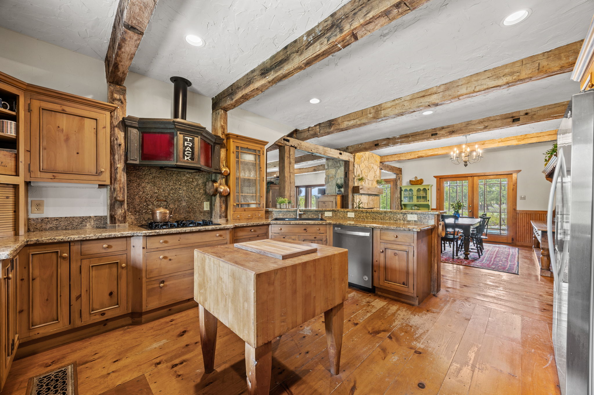 Kitchen features vintage vent hood