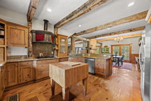 Kitchen features vintage vent hood