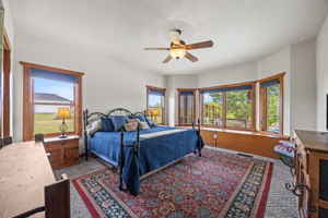 Primary bedroom has beautiful views of pool & pond