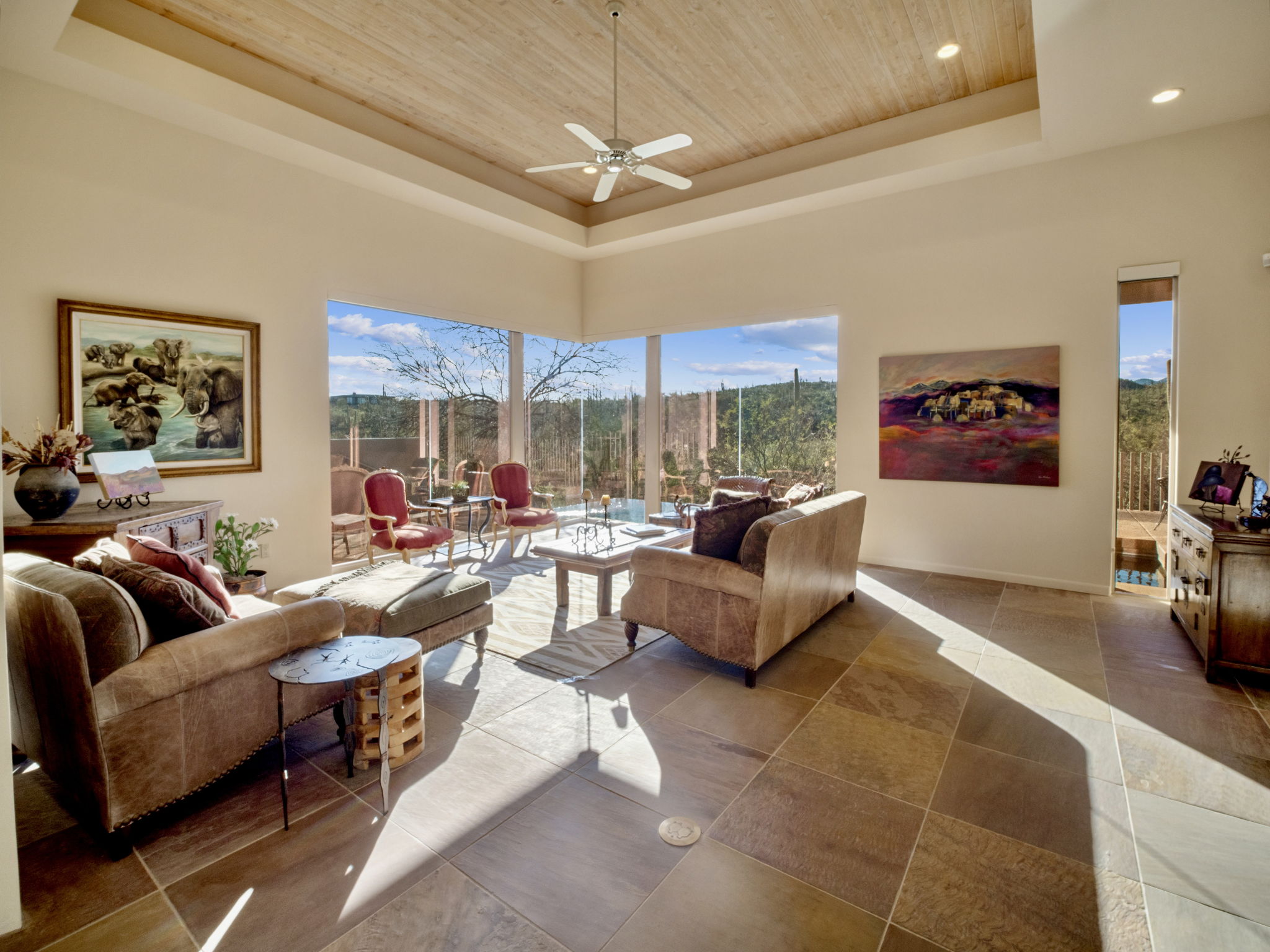 Living Room is characterized by its window walls and tray wood ceiling.