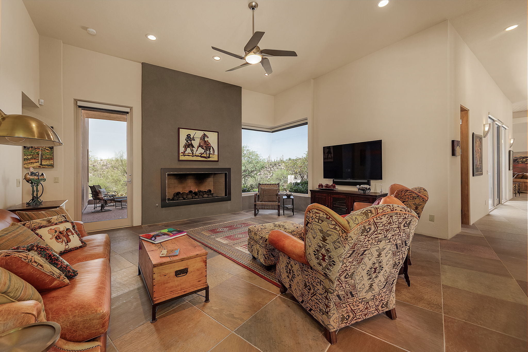 Family Room features a stunning gas fireplace and corner window wall with fabulous views.