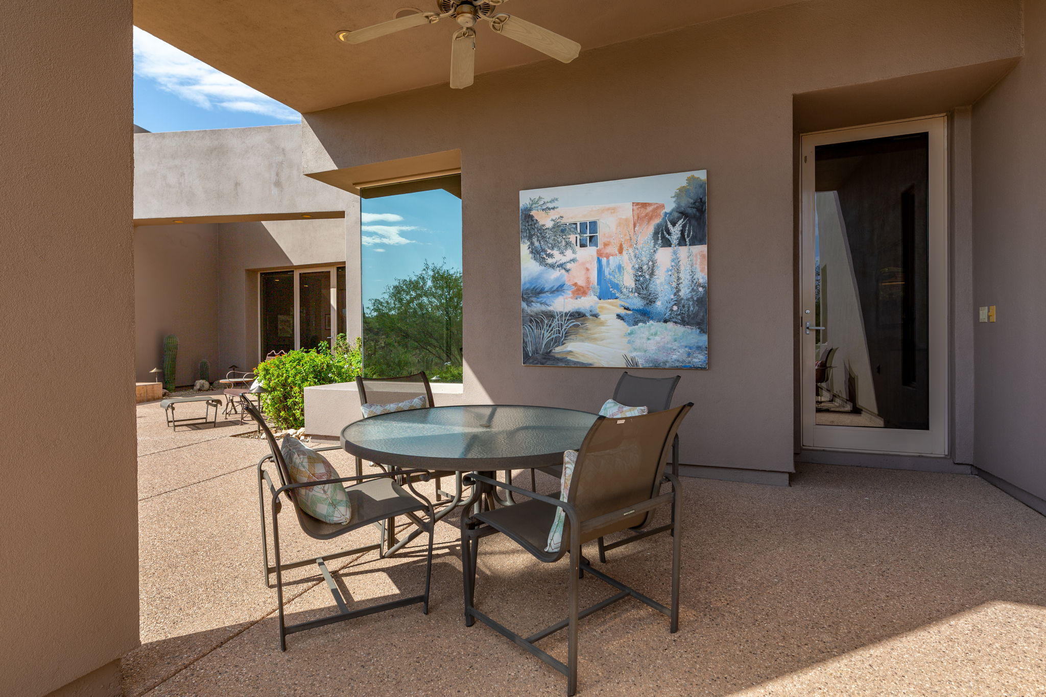 The rear patio provides a generously sized covered area complete with an outdoor ceiling fan.