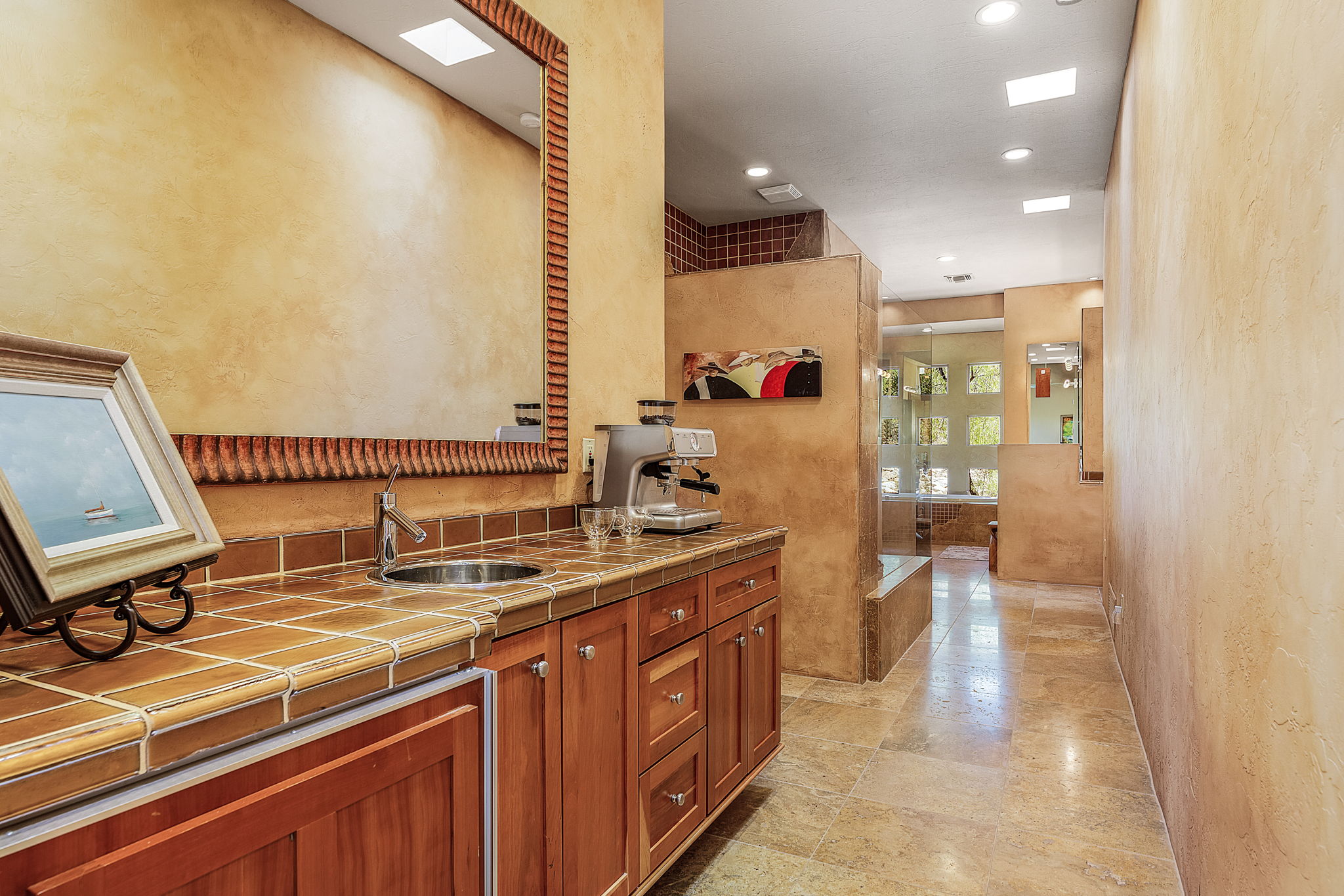 The ensuite bathroom features a wet bar, double vanity, two custom walk-in closets (one with a sauna and the other with a three-way mirror), two wet rooms (one with a toilet and the other with a toilet and a bidet), a jetted tub, central shower, and a work out room.