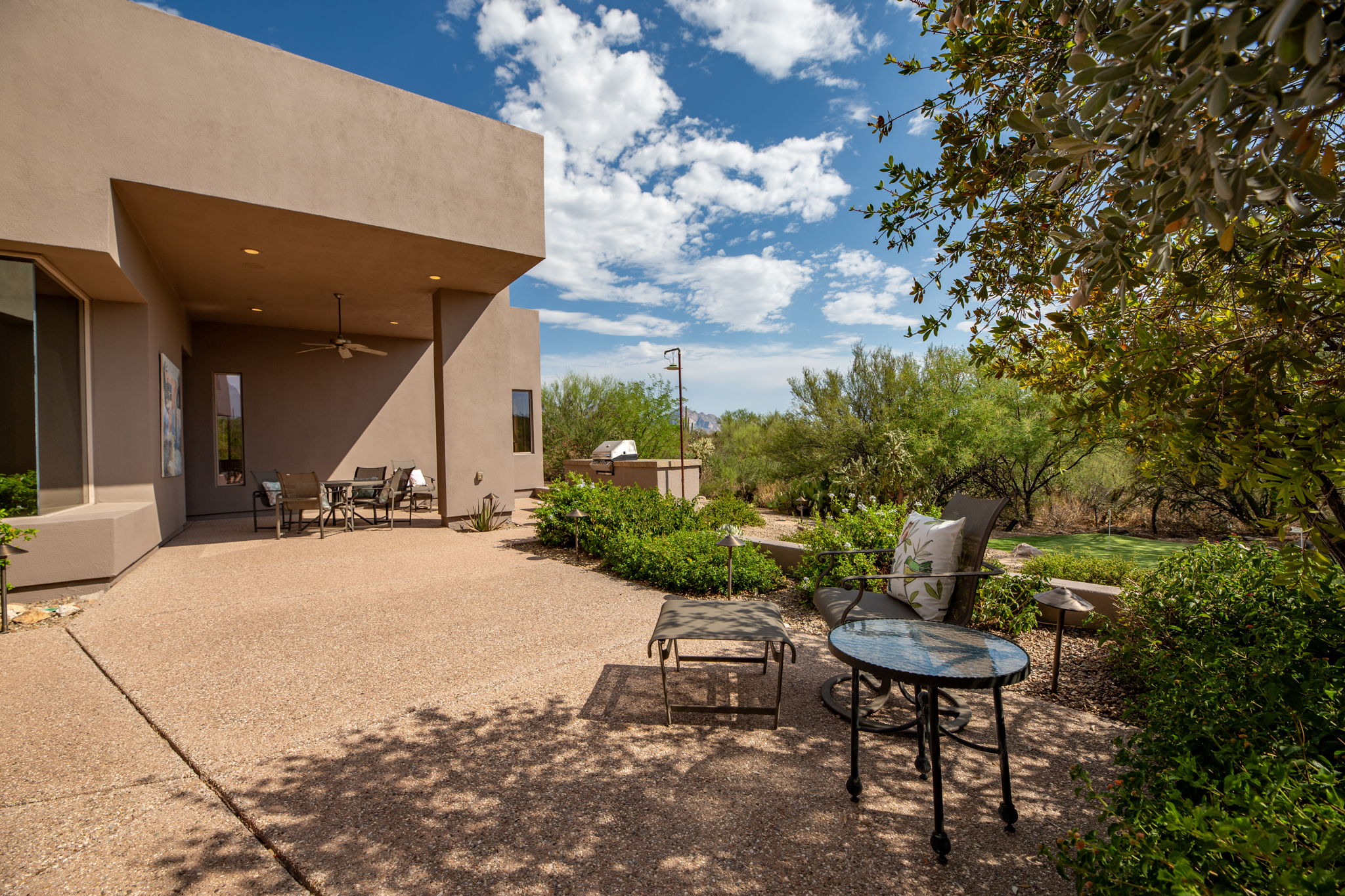 Rear Courtyard offers abundant space for seating and entertaining, and features a fire pit and built-in BBQ.