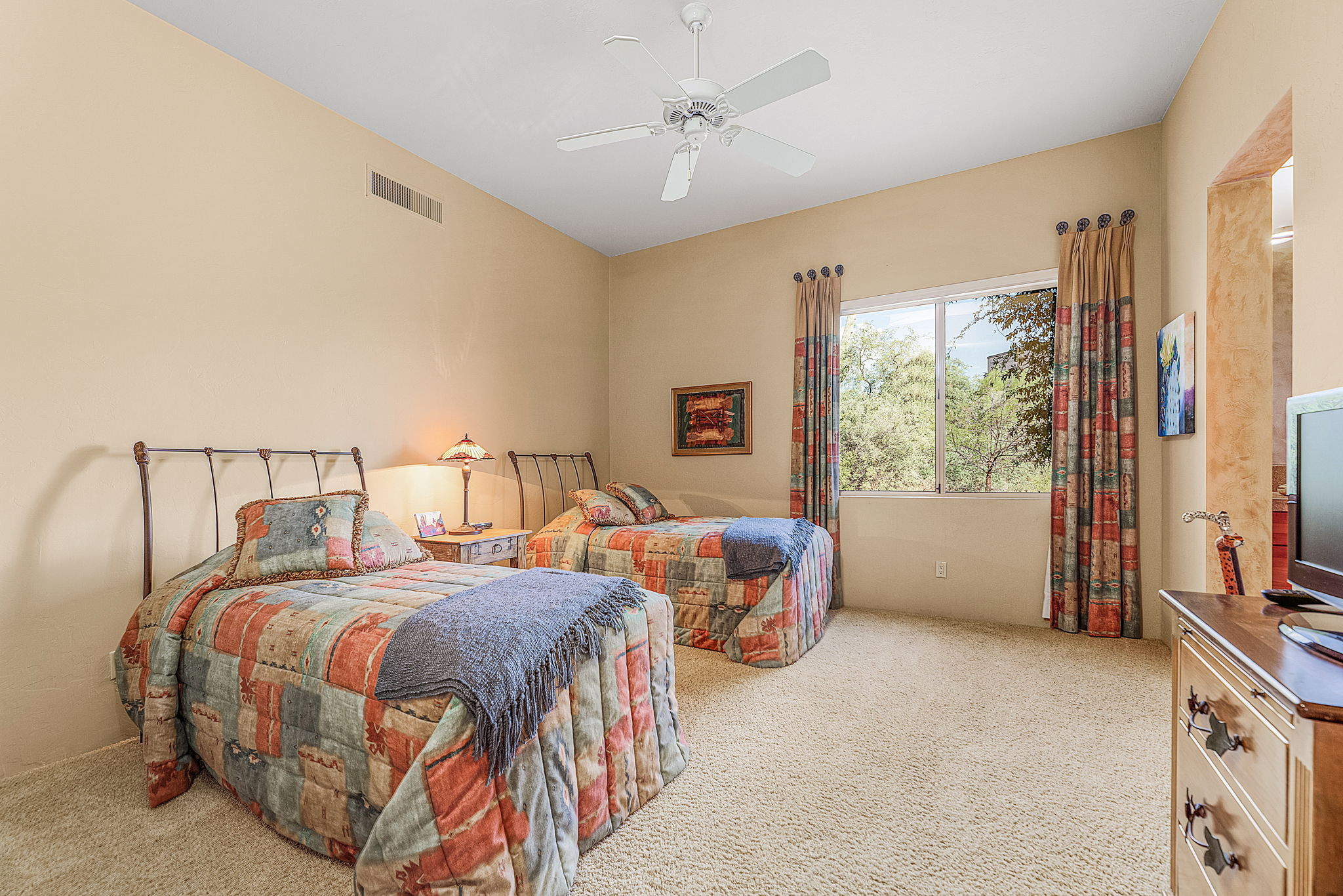 Bedroom 2 with ensuite vanity features a sliding door closet with built-in shelves.