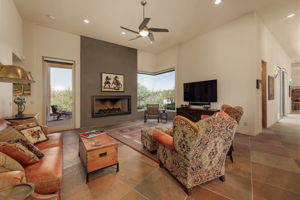 Family Room features a stunning gas fireplace and corner window wall with fabulous views.