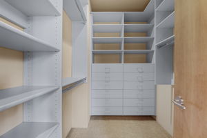 Bedroom 3 - Walk-in closet with shelves and drawers.