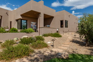 Flagstone path leads to a patio and putting green.