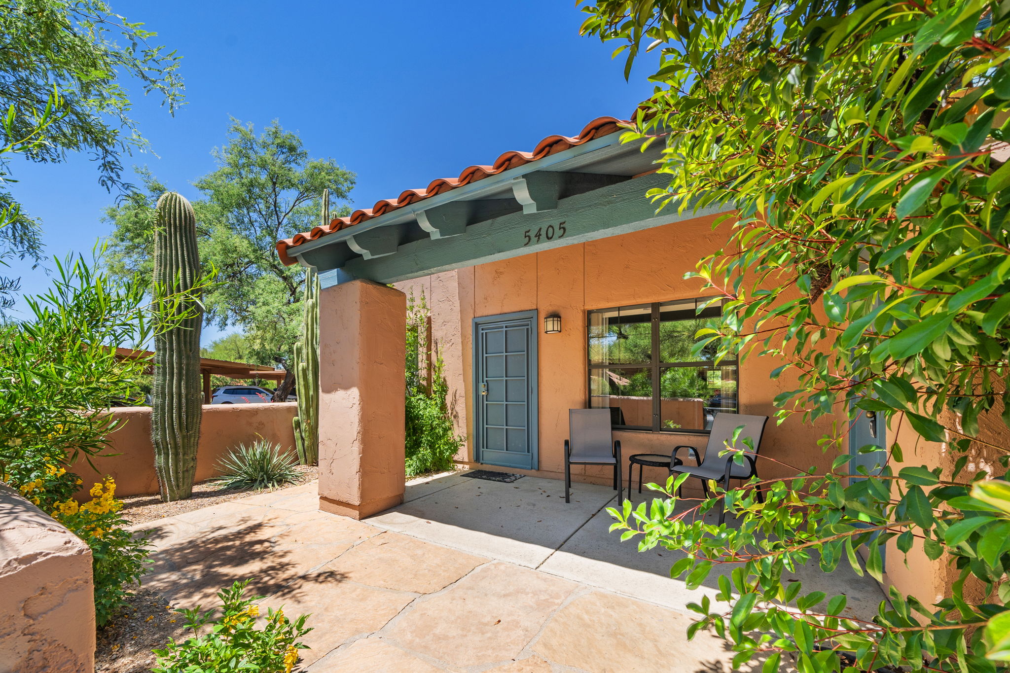 Large patio with flagstone surrounded by lush landscaping