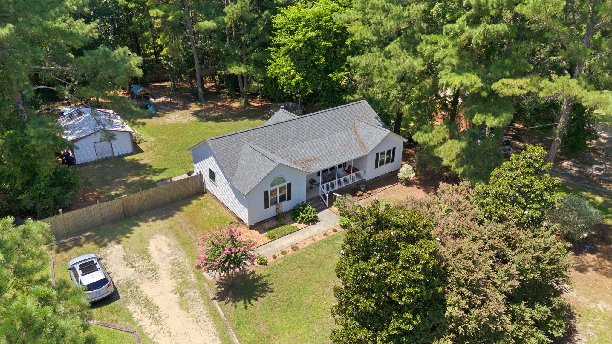Nearly one acre framed by mature trees