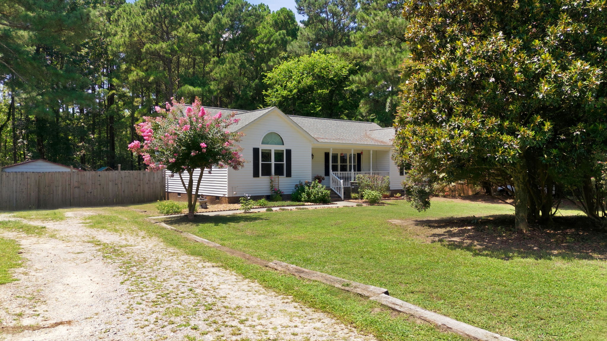 Spacious front yard with mature trees