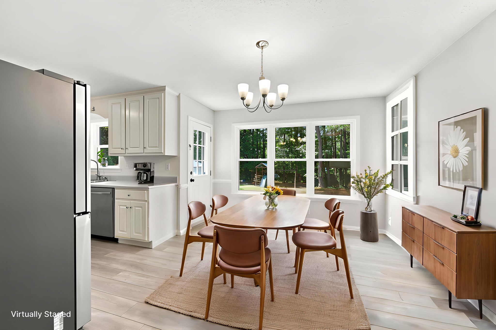 Sunlit dining area with backyard views