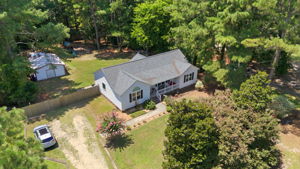 Nearly one acre framed by mature trees