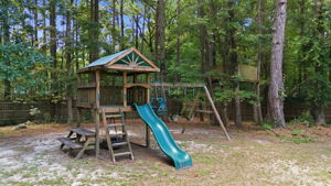 Wooden playset beneath a shaded canopy