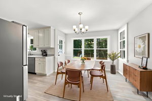 Sunlit dining area with backyard views