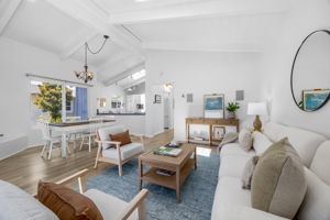 Open living/dining room with vaulted ceilings and a skylight.