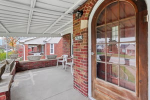 Covered Front Porch with Original Arched front door