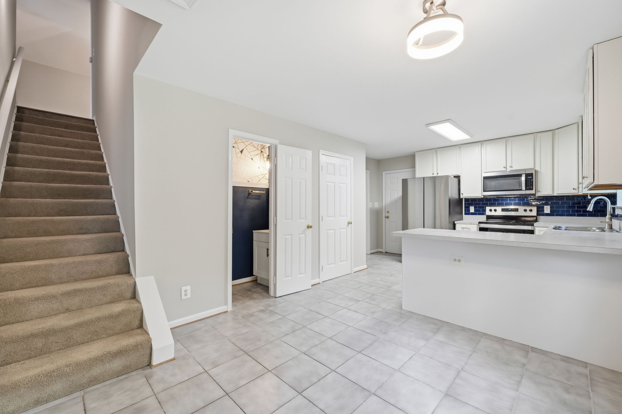 Eat-in Kitchen, half bath, and stairs to upper level