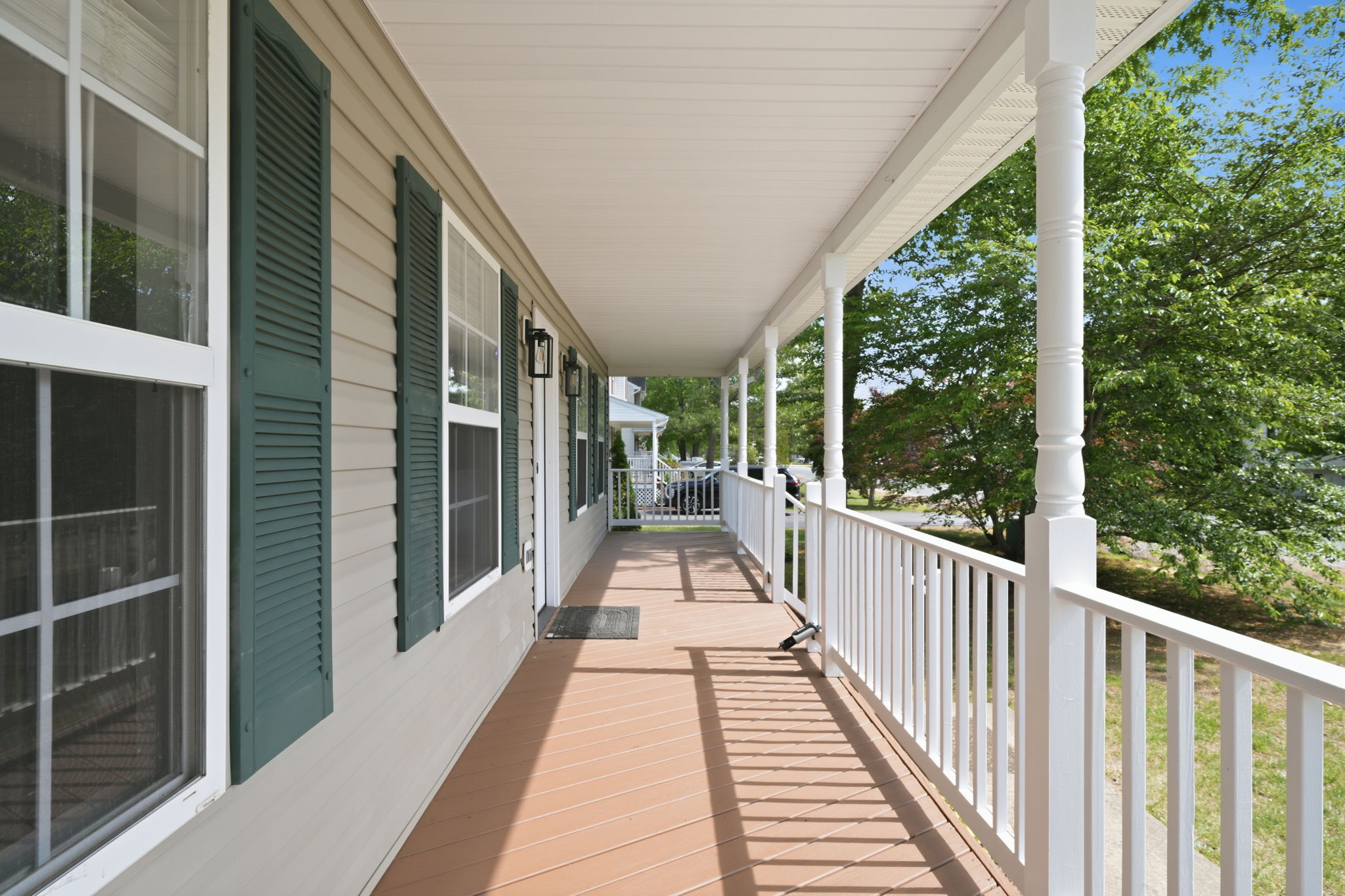 View of the covered front porch, newly painted and stained