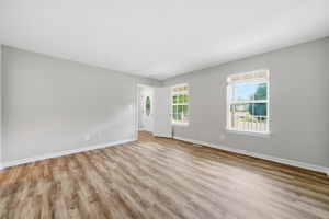 Main floor primary bedroom with view of front porch