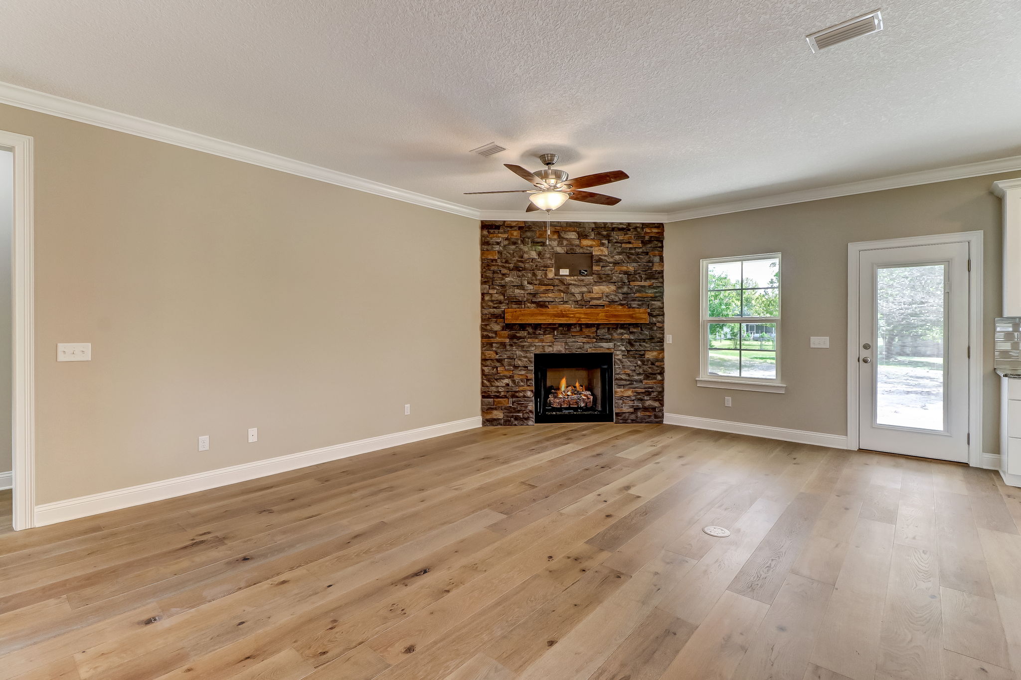 White Oak hardwood floors and a natural stone gas fireplace greet you, creating an attractive and inviting warm welcome.