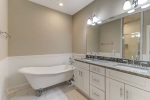 The owners suite offers privacy, comfort and plenty of natural light - don't miss the gorgeous claw foot bathtub and marble style tile in shower!