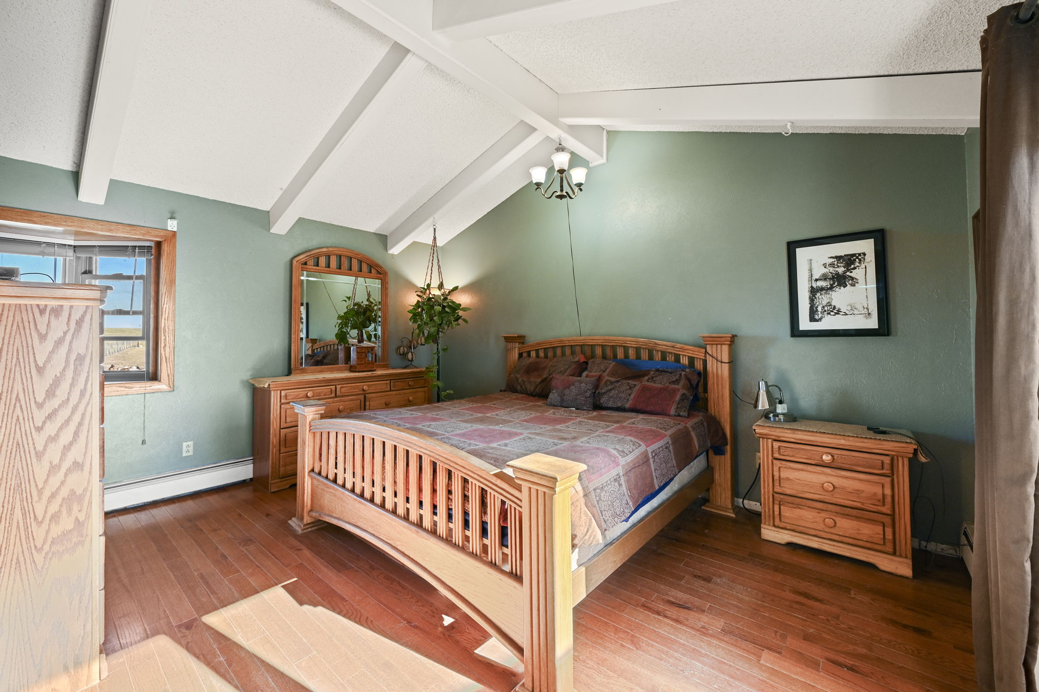 Primary bedroom with vaulted ceilings, walk-in closet and walk-out access