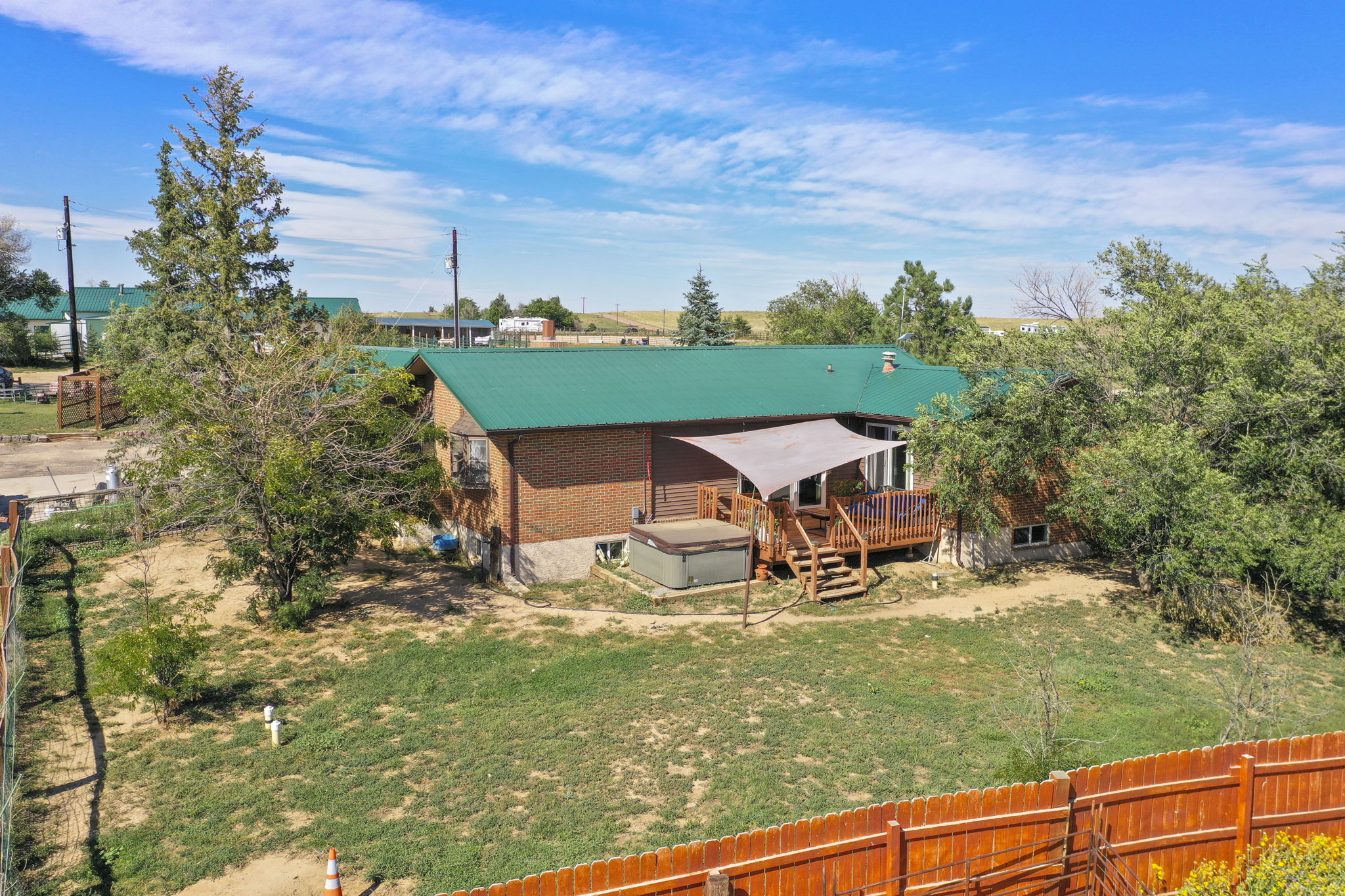 Main home fenced yard with deck and hot tub