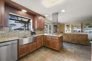 Kitchen with farmhouse sink, granite countertops with built-in Teppanyaki grill