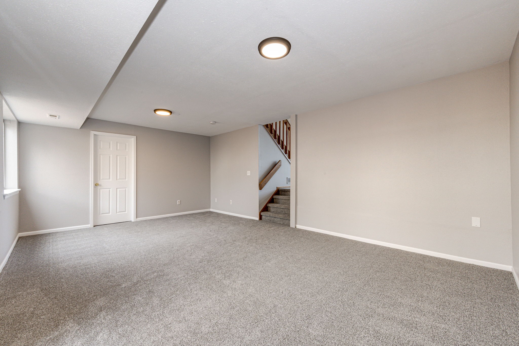 Corner view from the family room looking towards the stairs leading up to the main floor living room area