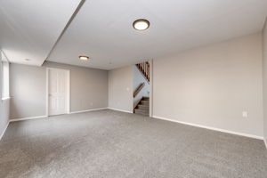 Corner view from the family room looking towards the stairs leading up to the main floor living room area
