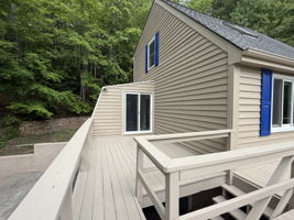 Side porch with access to the Sunroom. New sliding doors.