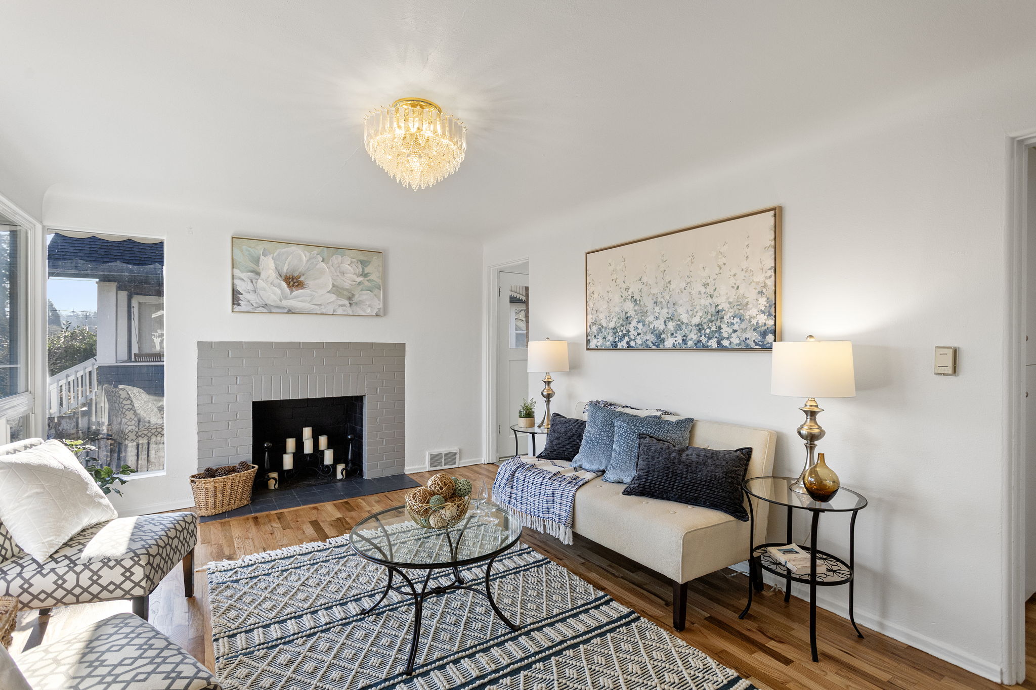 The living room welcomes you with period coved ceilings, refinished oak hardwoods, and a classic wood-burning fireplace.