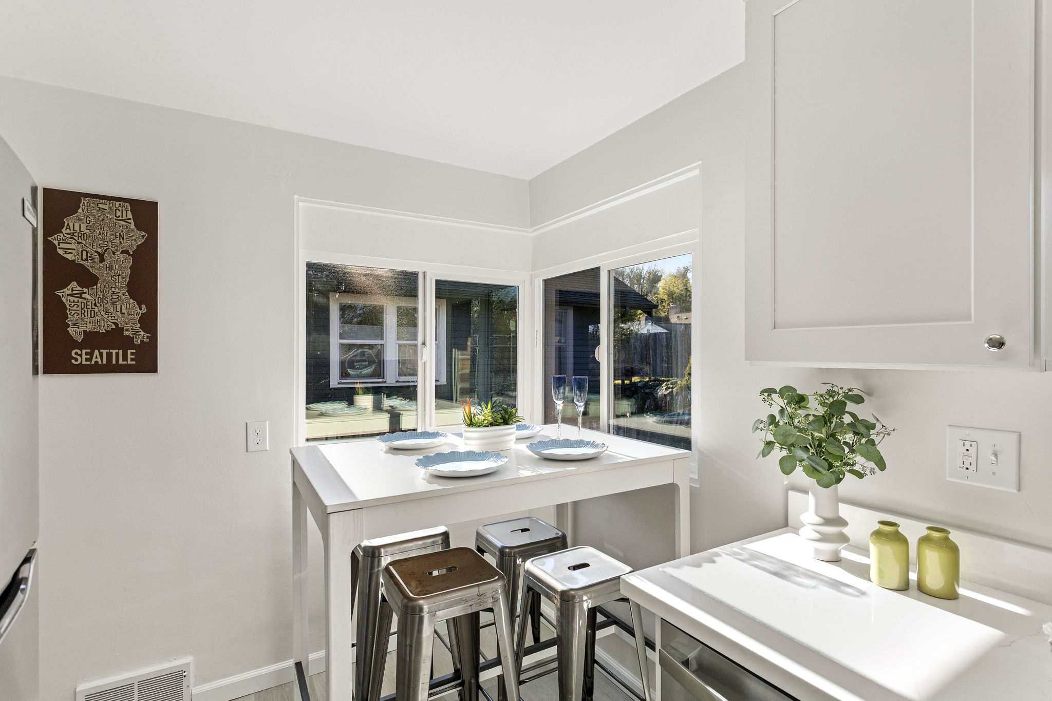 Just off the living room, the kitchen offers a bright corner eating space with natural light from multiple windows.