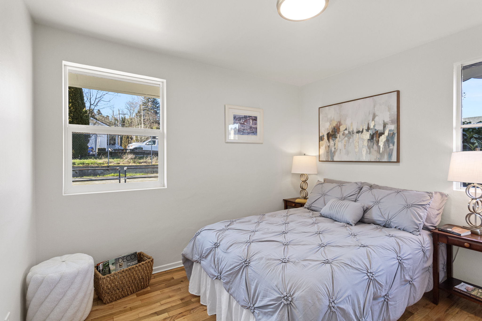 The west-facing back bedroom is filled with afternoon light and features hardwood floors and a comfortable, flexible layout.