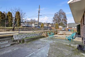 A generous concrete patio with western exposure, well suited for outdoor dining, grilling, and gathering, with flexibility to personalize over time.