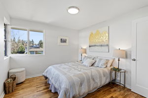 With three windows and a wider footprint than the other bedrooms, the front bedroom offers a notably open and comfortable feel.